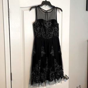 Semi formal short black dress with sparkle detail.